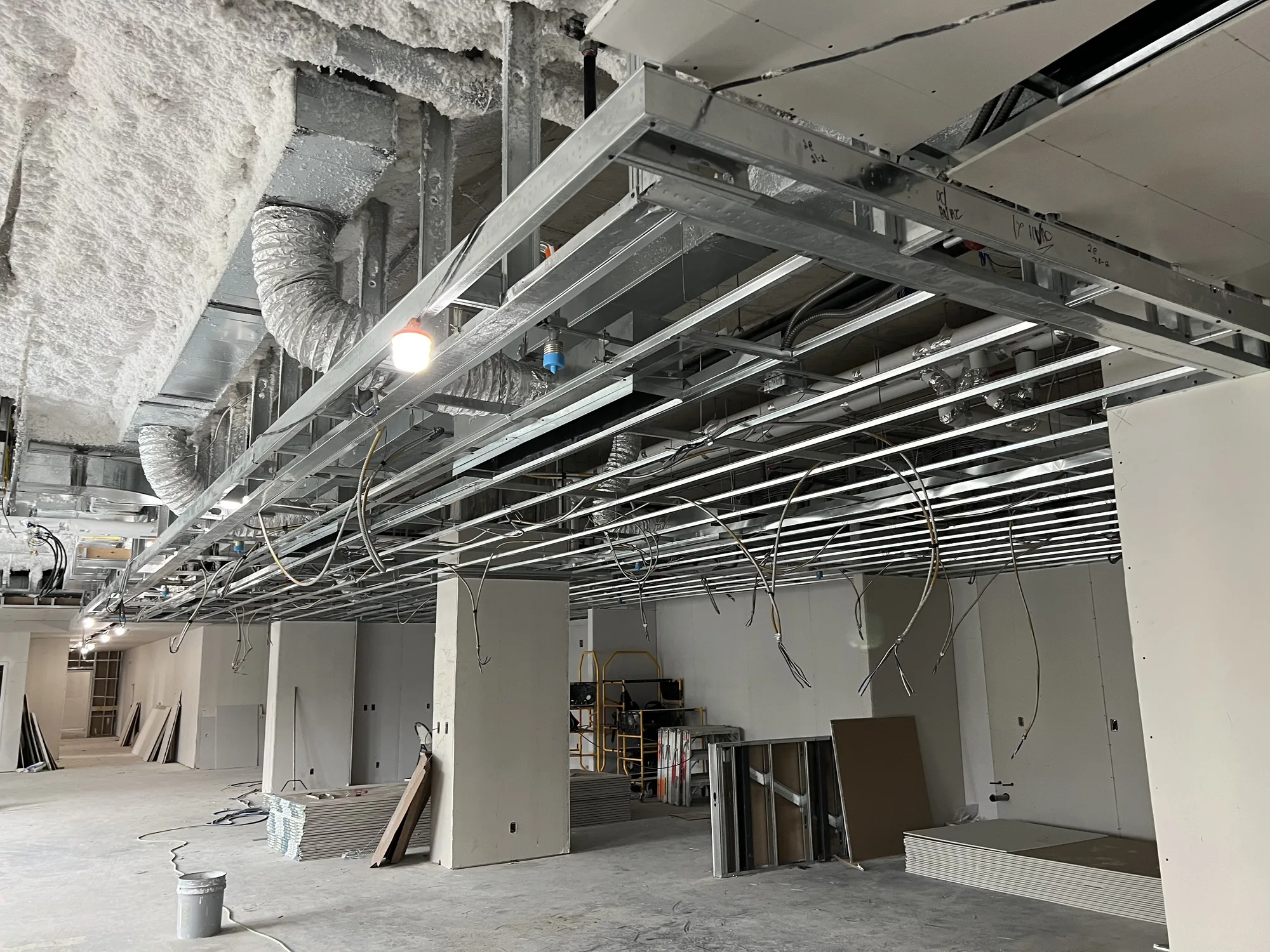 Steel ceiling framing and bulkheads above a commercial space