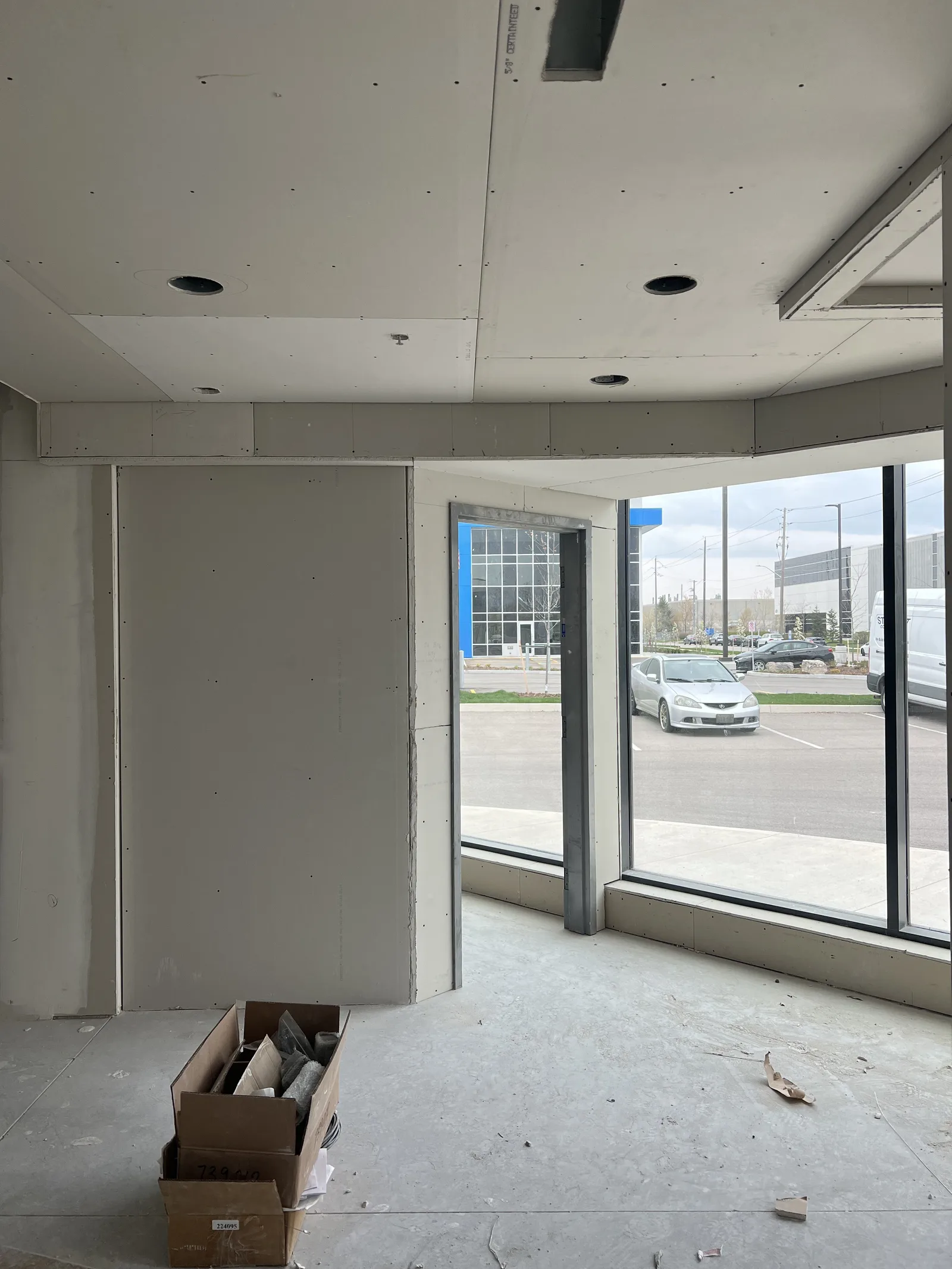 Finished drywall walls and ceiling in a bright corner room