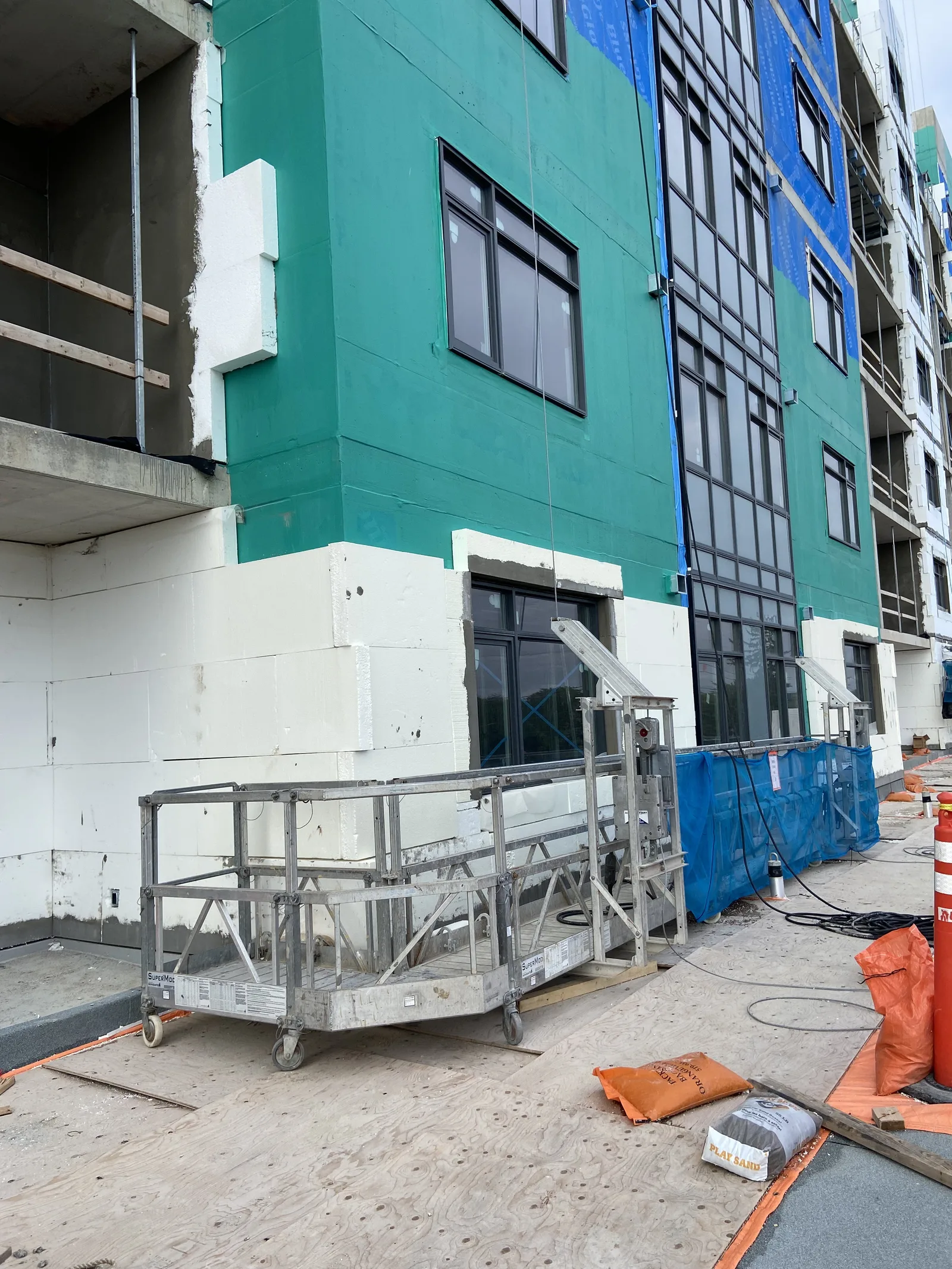 Exterior wall assembly with sheathing and a smooth finished facade