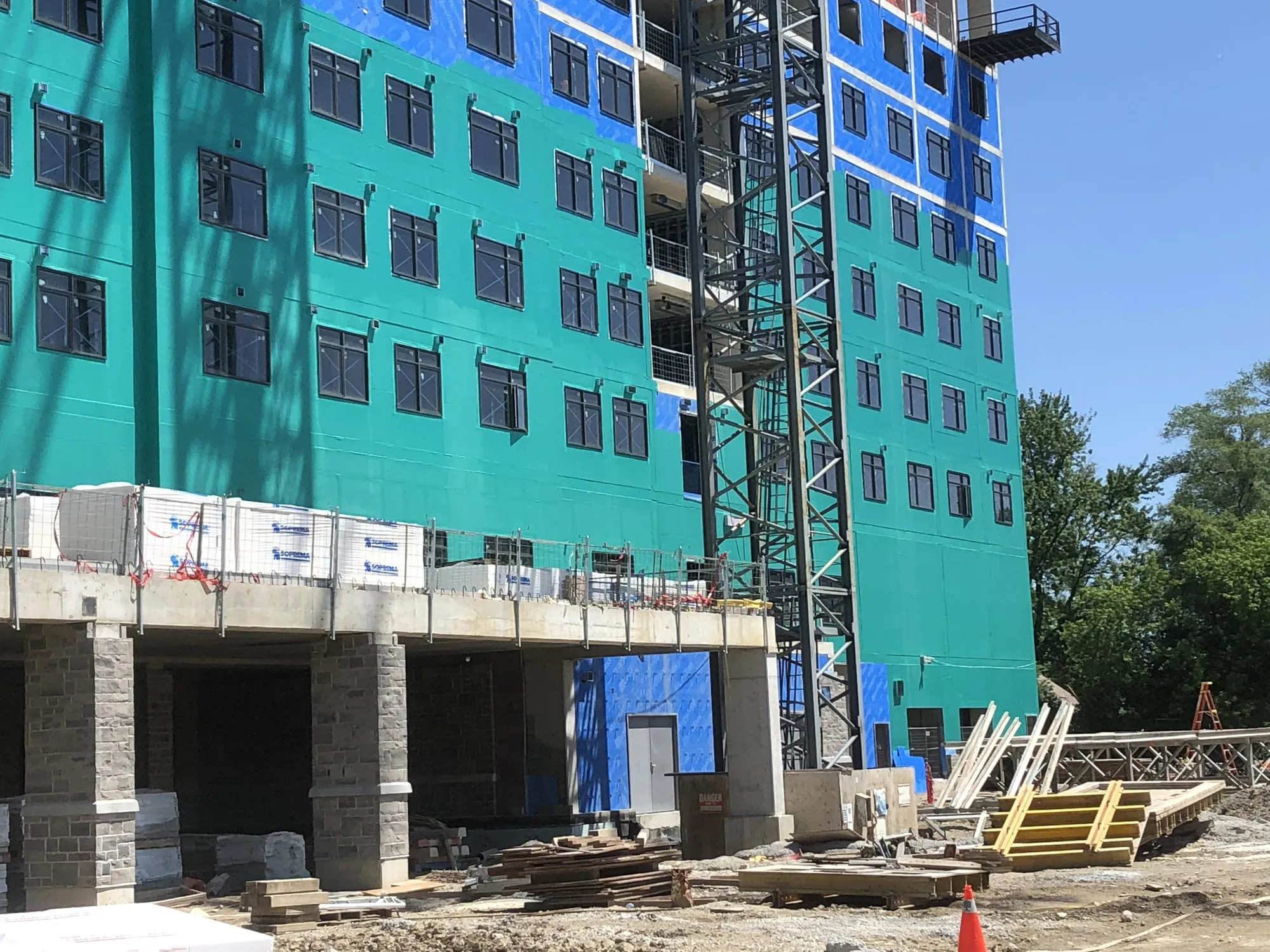 Mid-to-high rise building with exterior wall sheathing and window openings