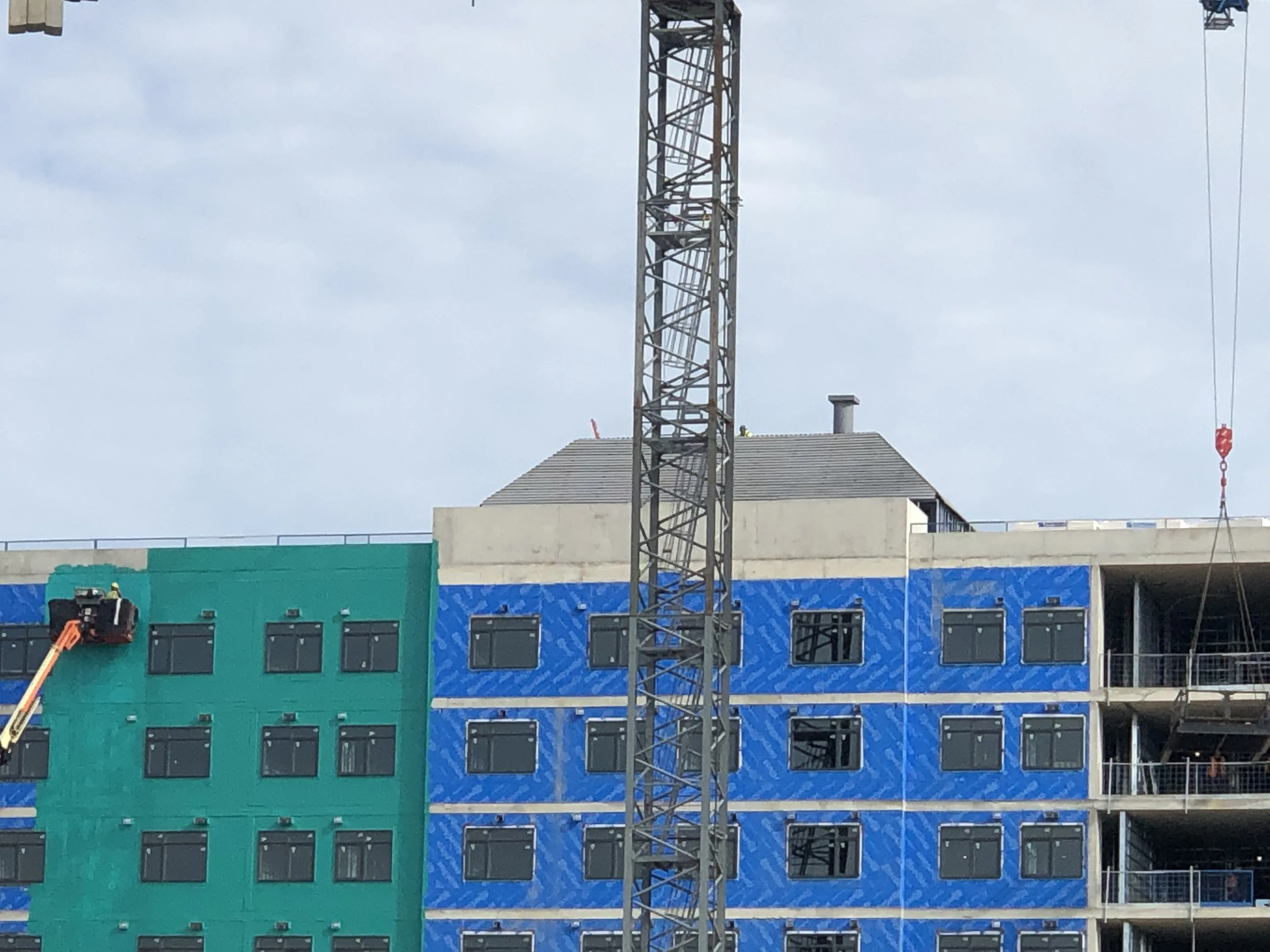 Tower crane over a multi-storey building during wall assembly