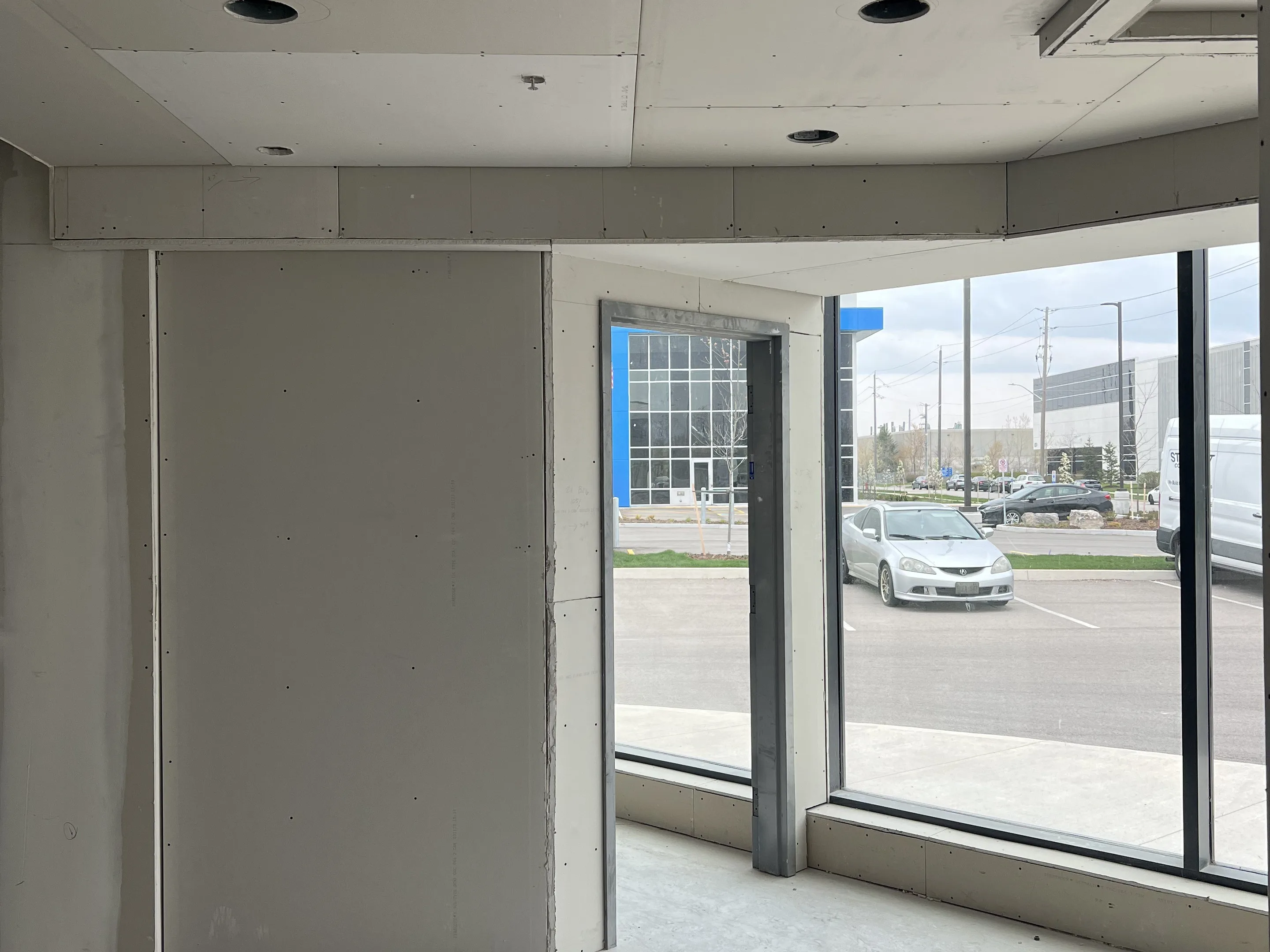 Finished drywall walls and ceiling in a bright corner room