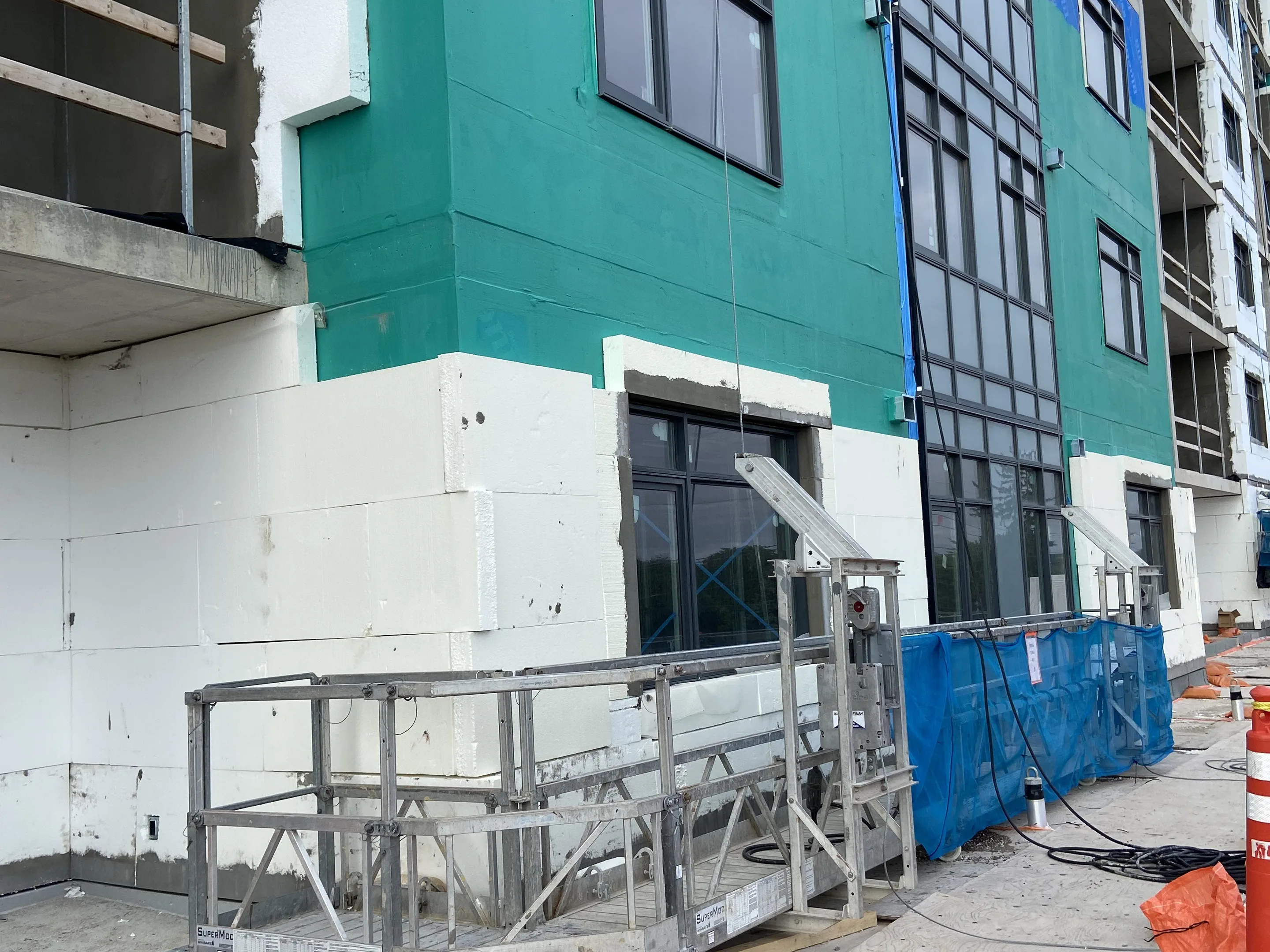 Exterior wall assembly with sheathing and a smooth finished facade