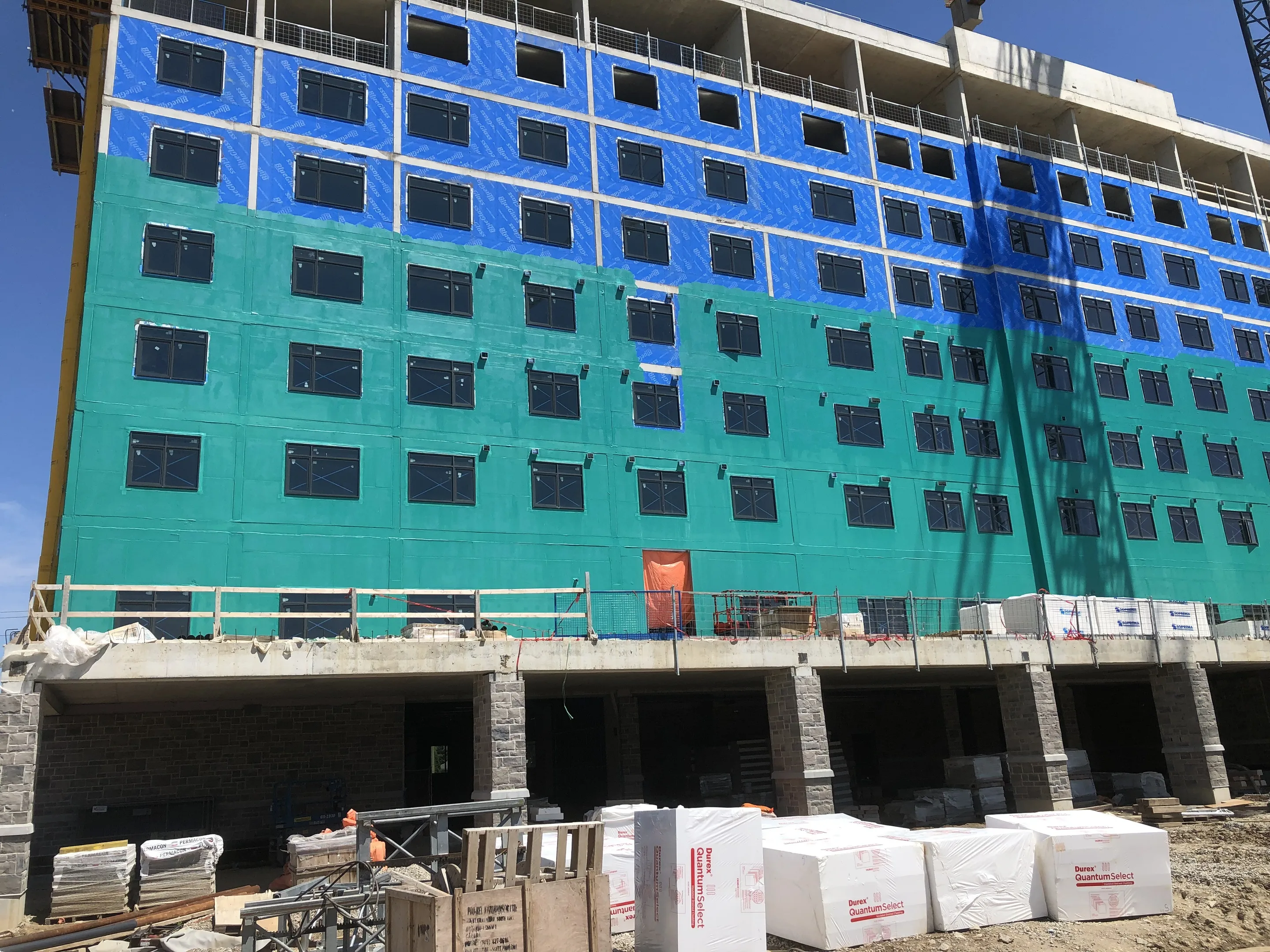 High-rise under construction with exterior sheathing installed floor by floor