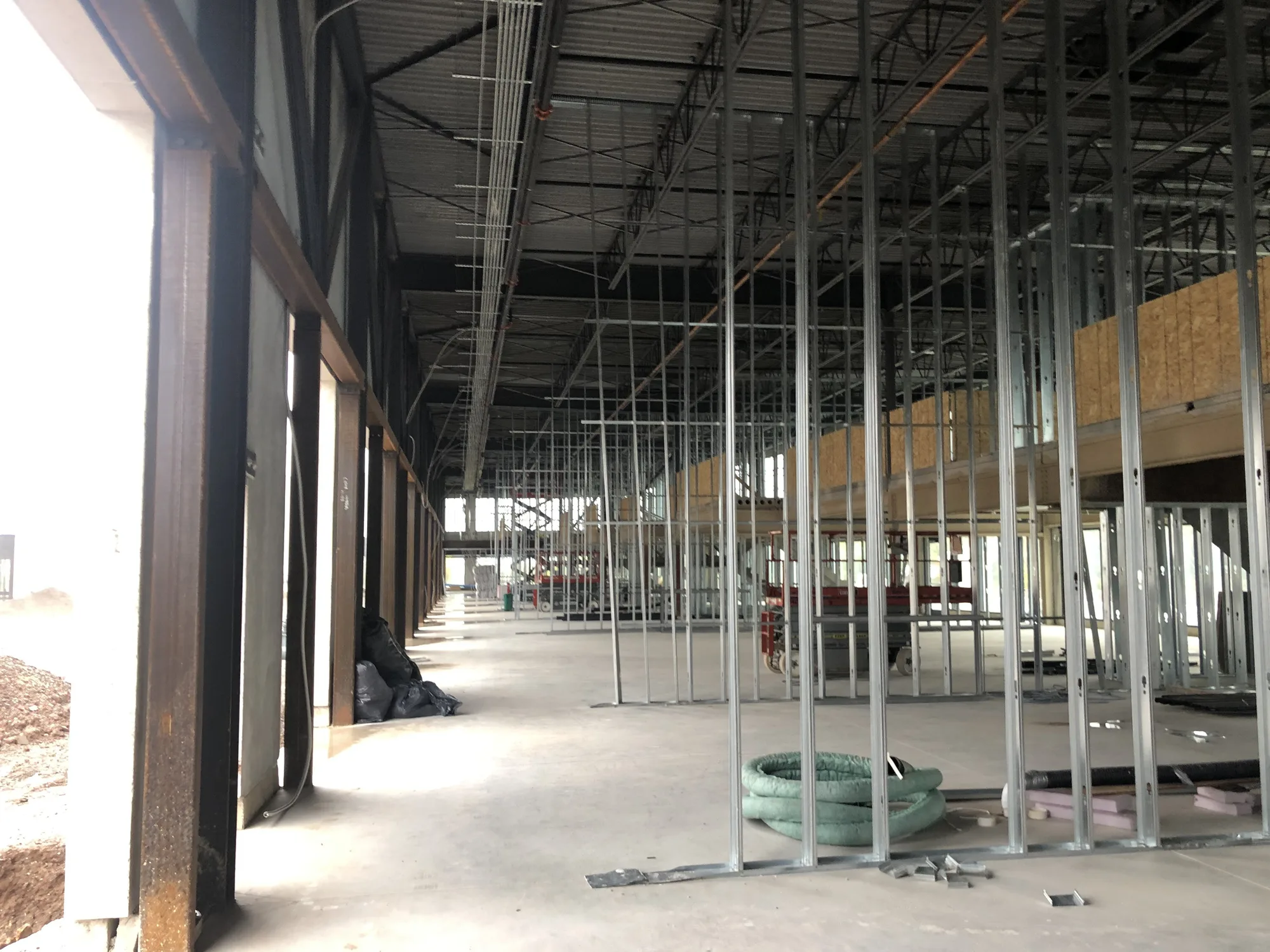 Steel stud framing laid out across an open commercial floor